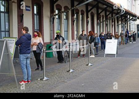 Prague, Czech Republic - April 15 2020: Coronavirus Covid-19 safety distance, people are waiting in long queue in front of shop with electronic Stock Photo