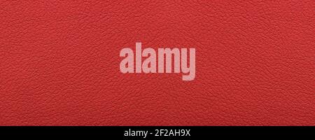 Clean red leather fullframe texture. Empty red leatherette closeup macro background. Stock Photo