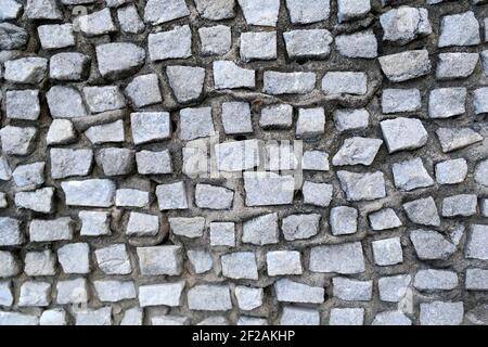 Gray abstract tile mosaic wall or floor as decorative  background. Soft focus. Close-up. Outdoors. Stock Photo