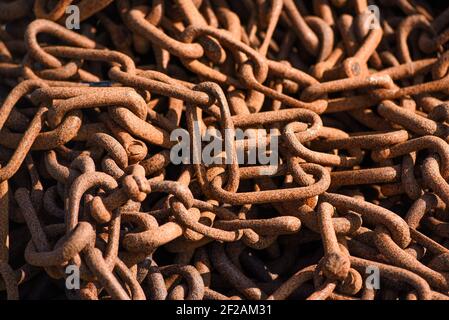 Old rusty chains in a fishing port, selective focus. Stock Photo