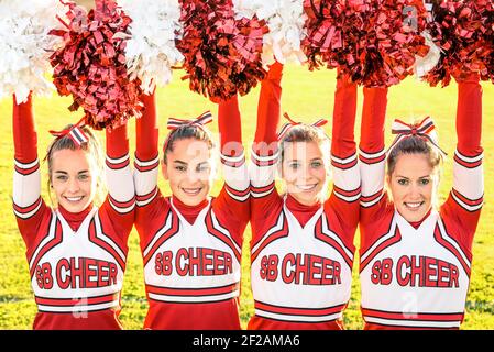 Cheerleaders team in action at high school playground Stock Photo