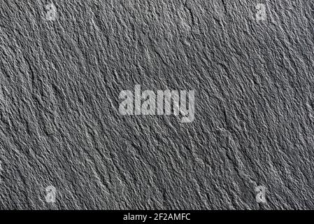Black slate stone texture, selective focus. Stock Photo