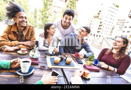 People group drinking cappuccino at coffee bar restaurant - Friends talking and having fun together at outdoors cafeteria - Life style concept Stock Photo