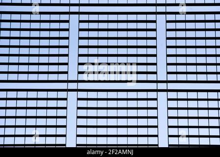 The texture of the steel structure in the shape of squares on the background of the blue sky. Stock Photo