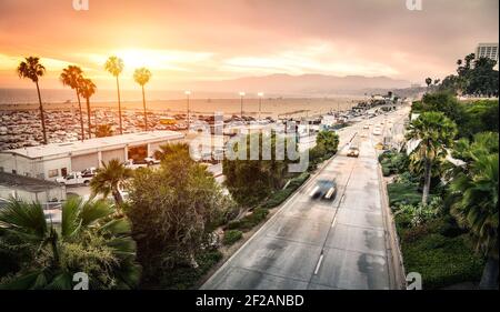 Aerial panoramic view of Ocean Ave freeway in Santa Monica beach at sunset - City streets of Los Angeles and California state surrounds Stock Photo