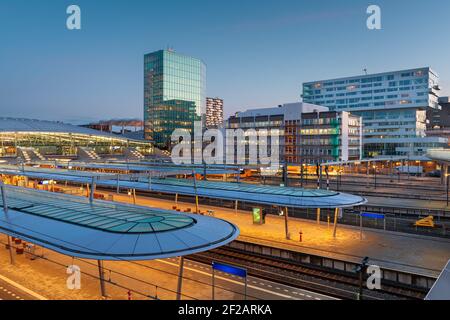 Utrecht, Netherlands cityscape over train station platforms at dawn. Stock Photo