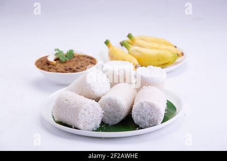 Puttu,steam cake ,white raw rice puttu , pacharisi maavu puttu with chana curry and banana  breakfast item made using rice flour Stock Photo