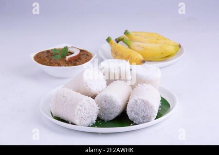 Puttu,steam cake ,white raw rice puttu , pacharisi maavu puttu with chana curry and banana  breakfast item made using rice flour Stock Photo