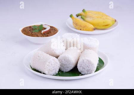 Puttu,steam cake ,white raw rice puttu , pacharisi maavu puttu with chana curry and banana  breakfast item made using rice flour Stock Photo