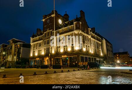 Historic Victorian building now Malmaison Hotel lit up at night with car light trails, Tower Place, Leith, Edinburgh, Scotland, UK Stock Photo