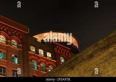 Guinness Gravity Bar at night with beautiful red illumination, modern and old architecture combined, roof top bar, 360 degree view, night shoot, Stock Photo