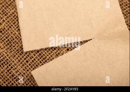Paper napkins on a background of homespun fabric with a rough texture. Close-up, selective focus. Stock Photo