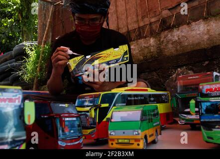 Bogor, Indonesia. 08th Mar, 2021. A man works to create a replica miniature, 3D-printed Indonesian bus papercraft at his workshop in Bogor, Indonesia on March 8, 2021. (Photo by Adrian Adi/INA Photo Agency/Sipa USA) Credit: Sipa USA/Alamy Live News Stock Photo