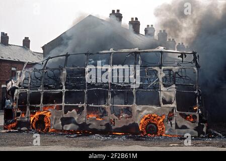 BELFAST, UNITED KINGDOM - JUNE 1972. Fire Bombed Hijacked Bus by the IRA during The Troubles, Northern Ireland, 1970s Stock Photo