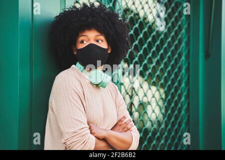 Latina woman with afro hair wearing protective mask. Portrait of African American woman. High quality photo Stock Photo