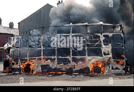 BELFAST, UNITED KINGDOM - JUNE 1972. Fire Bombed Hijacked Bus by the IRA during The Troubles, Northern Ireland, 1970s Stock Photo