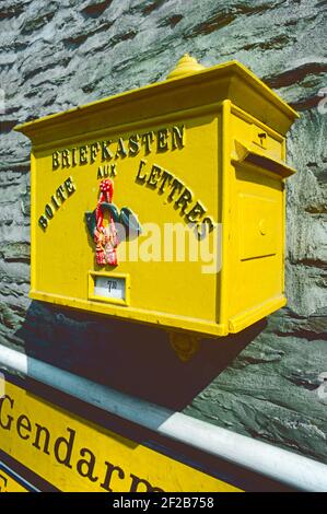 Vianden, Luxembourg. A bilingual (French and German) postbox in traditional yellow in this small Luxembourg town. Stock Photo