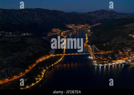 Aerial drone shot of Port Gruz by Dubrovnik bridge with lights in Croatia summer at dusk Stock Photo