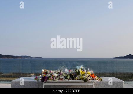 Tokyo, Japan. 11th Mar, 2021. Flowers are seen to commemorate victims of the Great East Japan Earthquake and Tsunami in Rikuzentakata, Iwate prefecture, Japan, March 11, 2021. Credit: Gang Ye/Xinhua/Alamy Live News Stock Photo