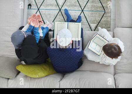 Top view of young muslim family reading Quran during Ramadan Stock Photo