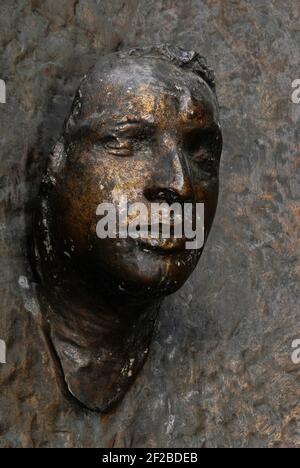 Jan Palach, Czech student who set himself on fire on 16 January 1969 in protest at the 1968 Soviet invasion of Czechoslovakia.  Bronze memorial on an external wall of Charles University, Prague, Czechia / Czech Republic.  Sculptor Olbram Zoubek (1926 - 2017) created the face in 1990, from a death mask taken in secret shortly after Palach self-immolated in nearby Wenceslas Square. The memorial is in a public space known in the communist era as the Square of Red Army Soldiers and re-named Jan Palach Square (Námestí Jana Palacha) after the 1989 Velvet Revolution in Czechoslovakia. Stock Photo