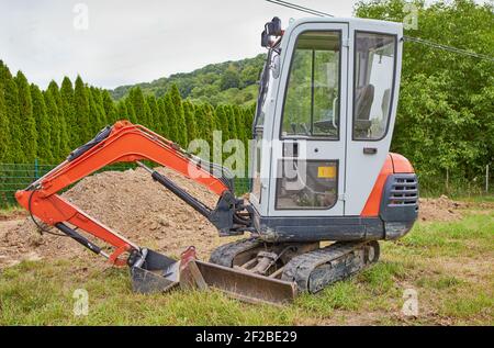 mini excavator on an empty lot Stock Photo
