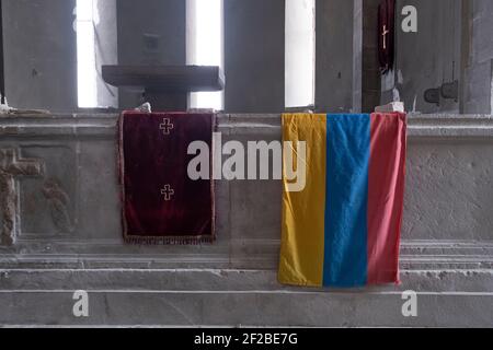 SHUSHI, NAGORNO KARABAKH - NOVEMBER 03: The Flag of Armenia is seen at the altar of the Armenian Apostolic Holy Savior Cathedral commonly referred to as Ghazanchetsots destroyed in a shelling attack by the Azerbaijani armed forces in the town of Shushi or Shusha in the self-proclaimed Republic of Artsakh or Nagorno-Karabakh, de jure part of the Republic of Azerbaijan on November 03 2020. The fighting between Armenia and Azerbaijan over Nagorno-Karabakh known also as the Artsakh Republic re-erupted in late September into a six-week war with both countries accusing each other of provocation that Stock Photo