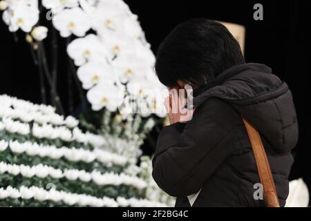 Tokyo, Japan. 11th Mar, 2021. A woman mourns for the victims of the Great East Japan Earthquake and Tsunami in Fukushima, Japan, March 11, 2021. Credit: Du Xiaoyi/Xinhua/Alamy Live News Stock Photo