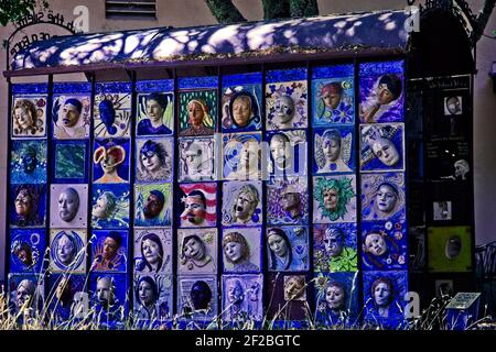 In the hills east of Santa Rosa, California, there is a grove of metal art sculptures called Marijke's Grove. This 'Peace Or War Wall' of faces Stock Photo