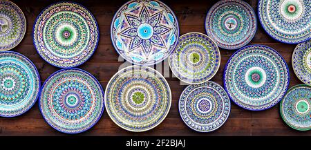 Samara, Russia - June 4, 2016: Ethnic Uzbek ceramic round plates with traditional Uzbek ornaments. Decorative ceramic plates with patterns