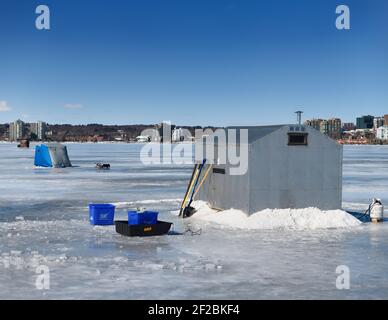 Ice fishing cabin and tents on frozen Kempenfelt Bay of Lake Simcoe at Barrie Canada in winter Stock Photo