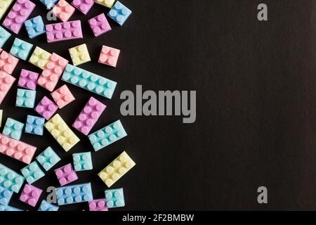 Building blocks on black background with empty space on one side Stock Photo