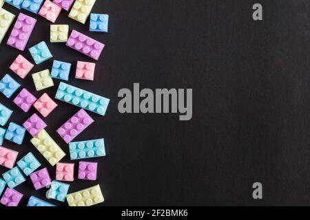 Building blocks on black background with empty space on one side Stock Photo