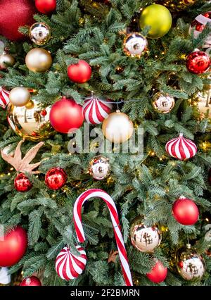 Christmas tree with colourful decorations outside shop in Kensington High St, London Stock Photo