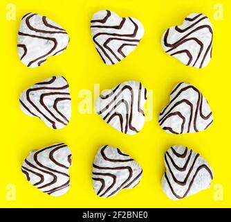Gingerbread on a yellow background. Gingerbread coated with sugar glaze and chocolate. Seamless pattern. Stock Photo