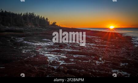 The sun sets over a beach near Annapolis in Nova Scotia, Canada Stock Photo