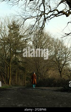Woman walking in the woods Stock Photo