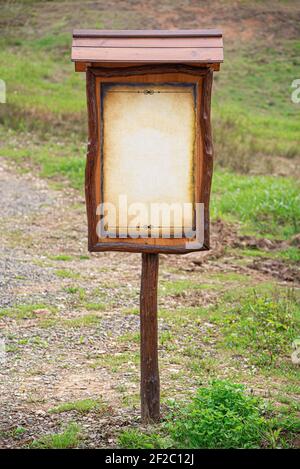 Signpost sign with blank sheet on the background of grass and countryside Stock Photo