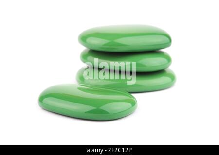 Green spa stones on a white background. Focus on foreground. Stock Photo