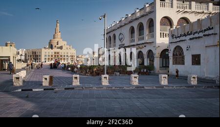 Souk Waqif in Doha Qatar daylight exterior view  showing Al-Fanar Qatar Islamic Cultural Center  with clouds in sky in background Stock Photo