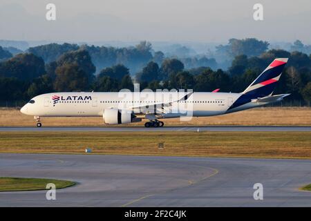 LATAM Qatar Airways Airbus A350-900 A7-AMC passenger plane arrival and landing at Munich Airport Stock Photo