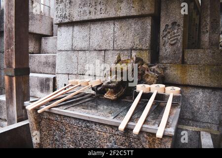 Kyoto, Japan - March 30th 2019; Fushimi Inari Taisha, Temizuja - water tank for ritual of washing the hands and mouth Stock Photo