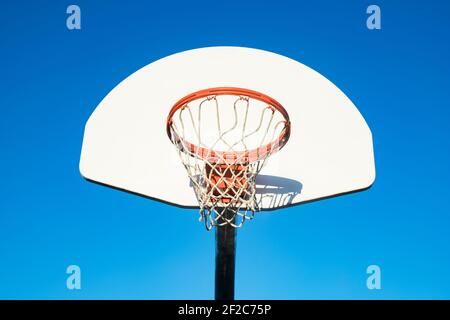 Basketball hoop on blue sky background in th school yard Stock Photo