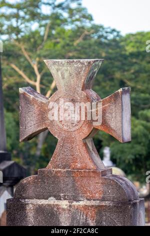 Stone cross on cemetery grave Stock Photo