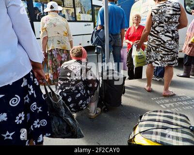 Women on the  stop of suburban bus to an outing to the country in the summer, Saint-Petersburg, Russia, 2012 Stock Photo