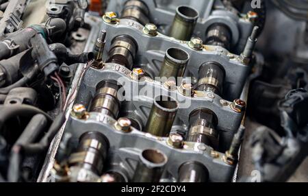 Cylinder head of auto parts While the technician opens to set the valve to meet the factory standard, selective soft focus. Stock Photo