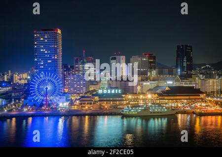 Kobe Cityscape Harbor Waterfront Panorama at Night. Illuminated Skyscrapers and the glowing urban sprawl view from view from the seaside, Kobe, Japan Stock Photo