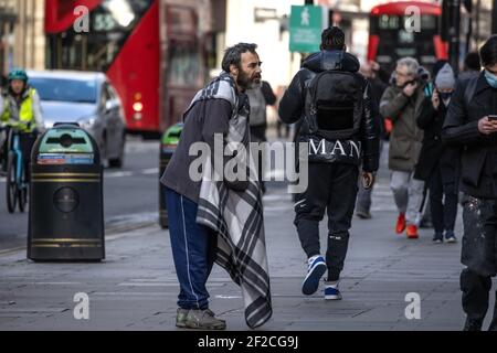 Homeless man beggaring for money at Oxford Circus, Central London, England, United Kingdom Stock Photo