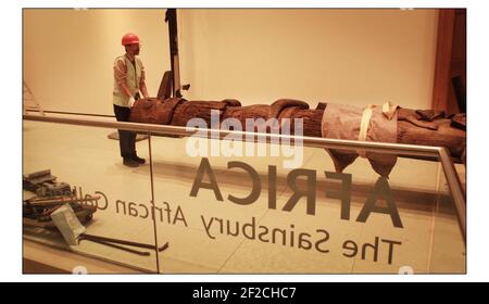 An early and important TOTEM POLE from the Nisga'a Nation, British Colombia raised into position at the British Museum with Chief Gadeelip (literally 'Cheif Anchor') master carver and member of the Nisga'a Eagle-Beaver clan on hand to watch the process. The magnificent 8 meter red cedar pole will be one of the star objects in the forthcoming exhibition LIVING and DYING opening on 3 November.pic David Sandison 17/10/2003 Stock Photo