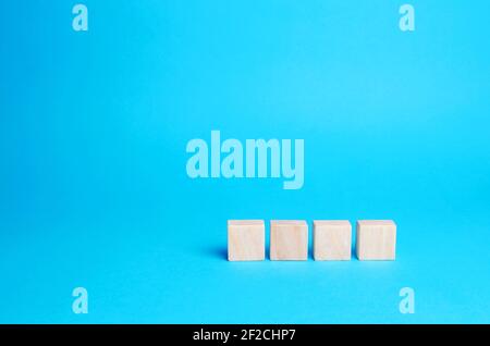 Empty wooden blocks on a blue background. Copy space, place for text and icons. Add numbers and letters. Blank for design, mockup Stock Photo